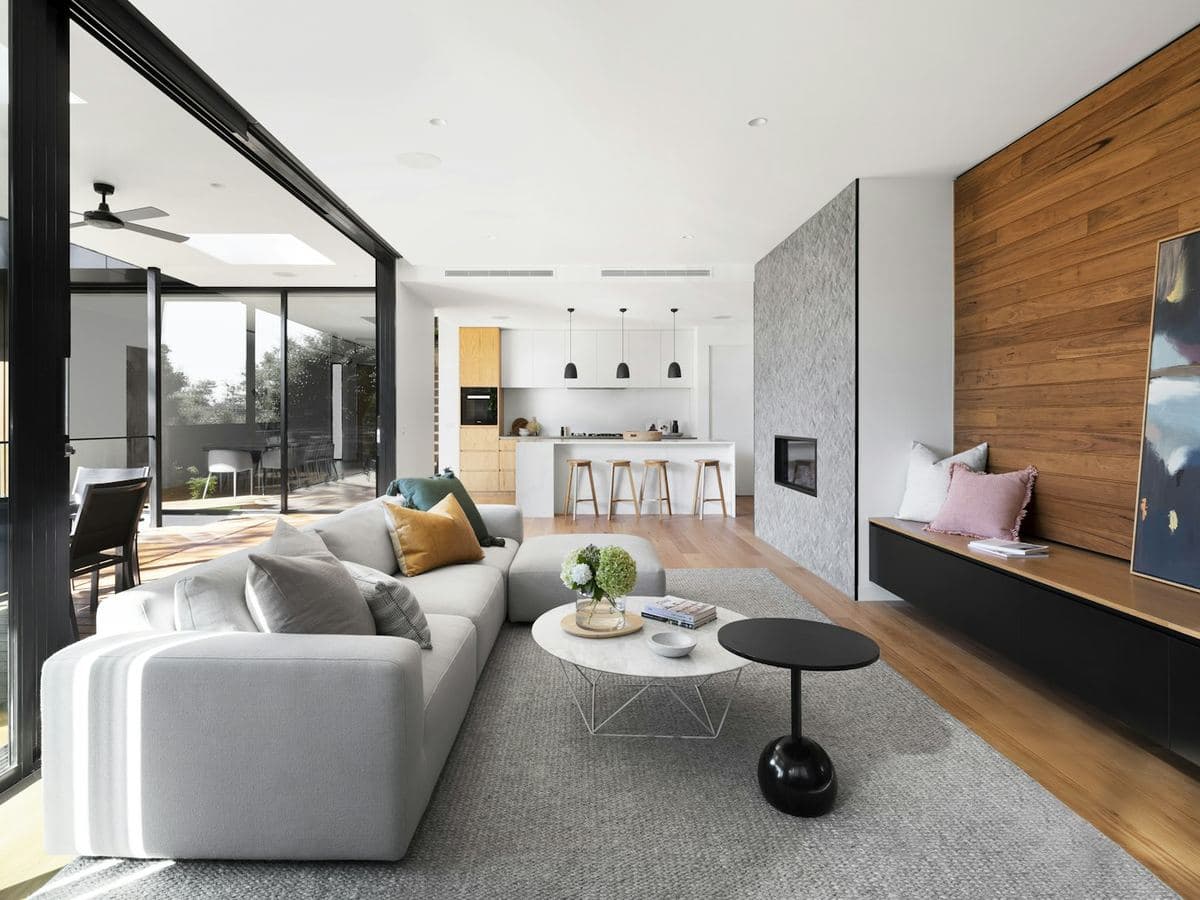 A modern home with a pool and paved patio